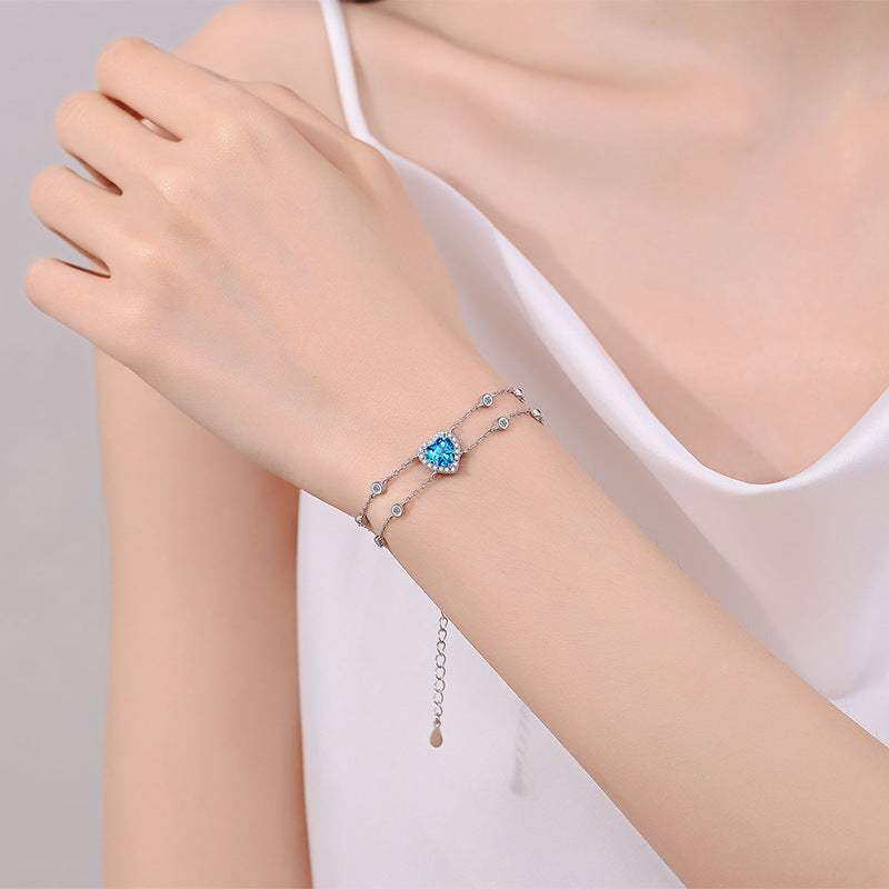 Princess Celestial Bracelet: Choose 1ct Moissanite, 1ct Blue Moissanite, or 6.5mm Heart Zircon. Set in rhodium-plated sterling silver.